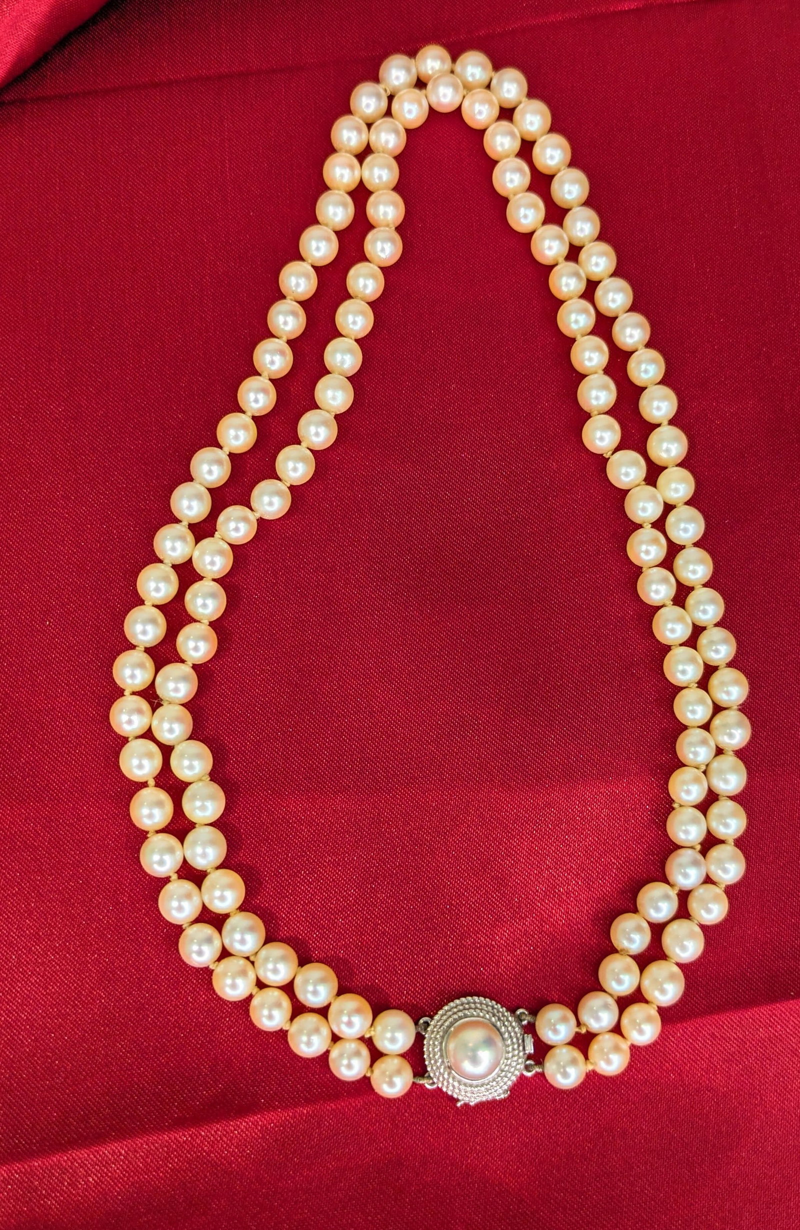 Double Strand Pearl Necklace: The clasp is crafted in 18k white gold. The pearls measure 6-6 1/2mm. The necklace measures 15in in length.