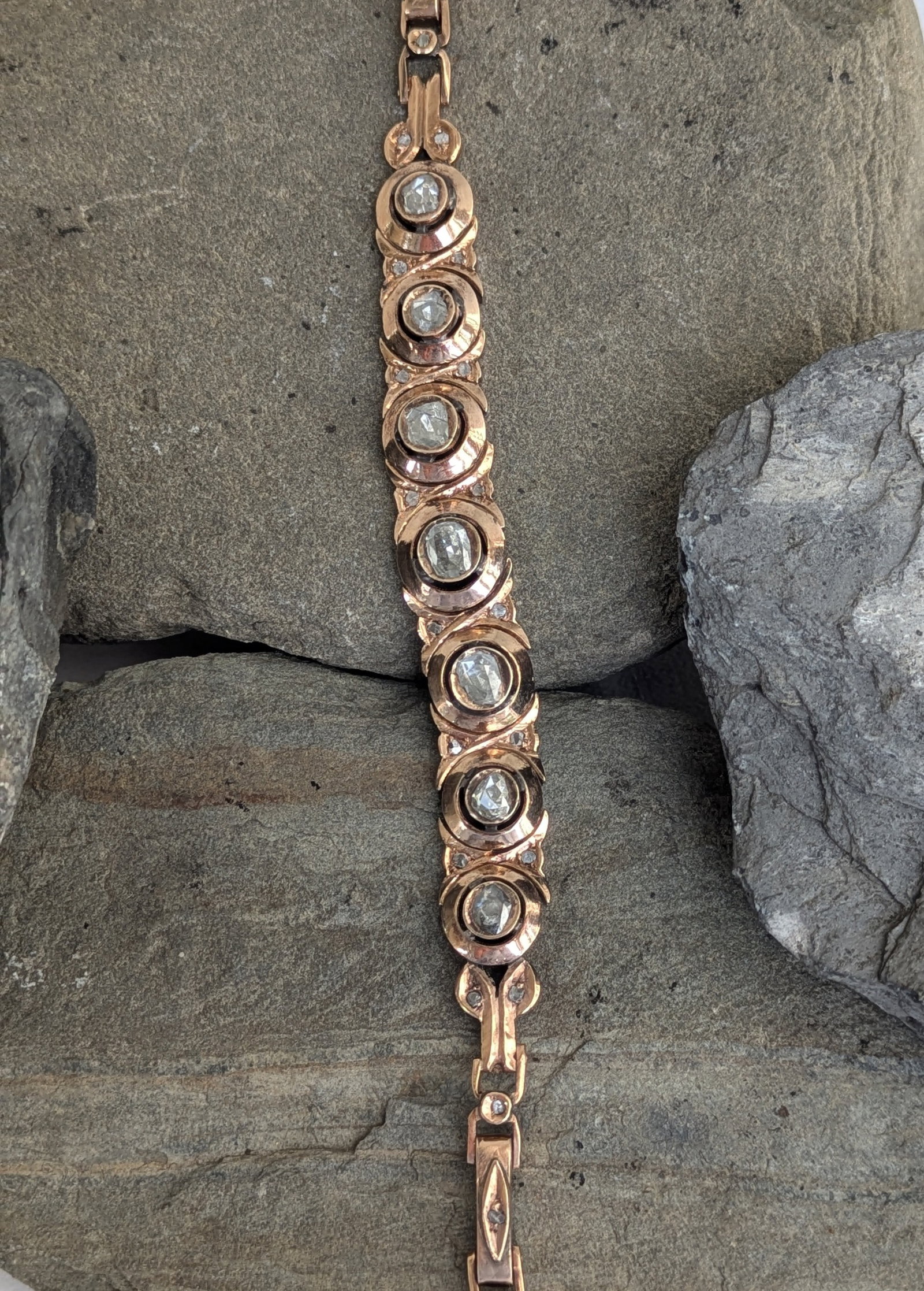 Antique Rose Cut Diamond Bracelet: Crafted in 10k rose gold featuring (27) rose cut diamonds weighing approximately 1.75cttw. The bracelet measures 7 1/2in in length and weighs 15.9dwt