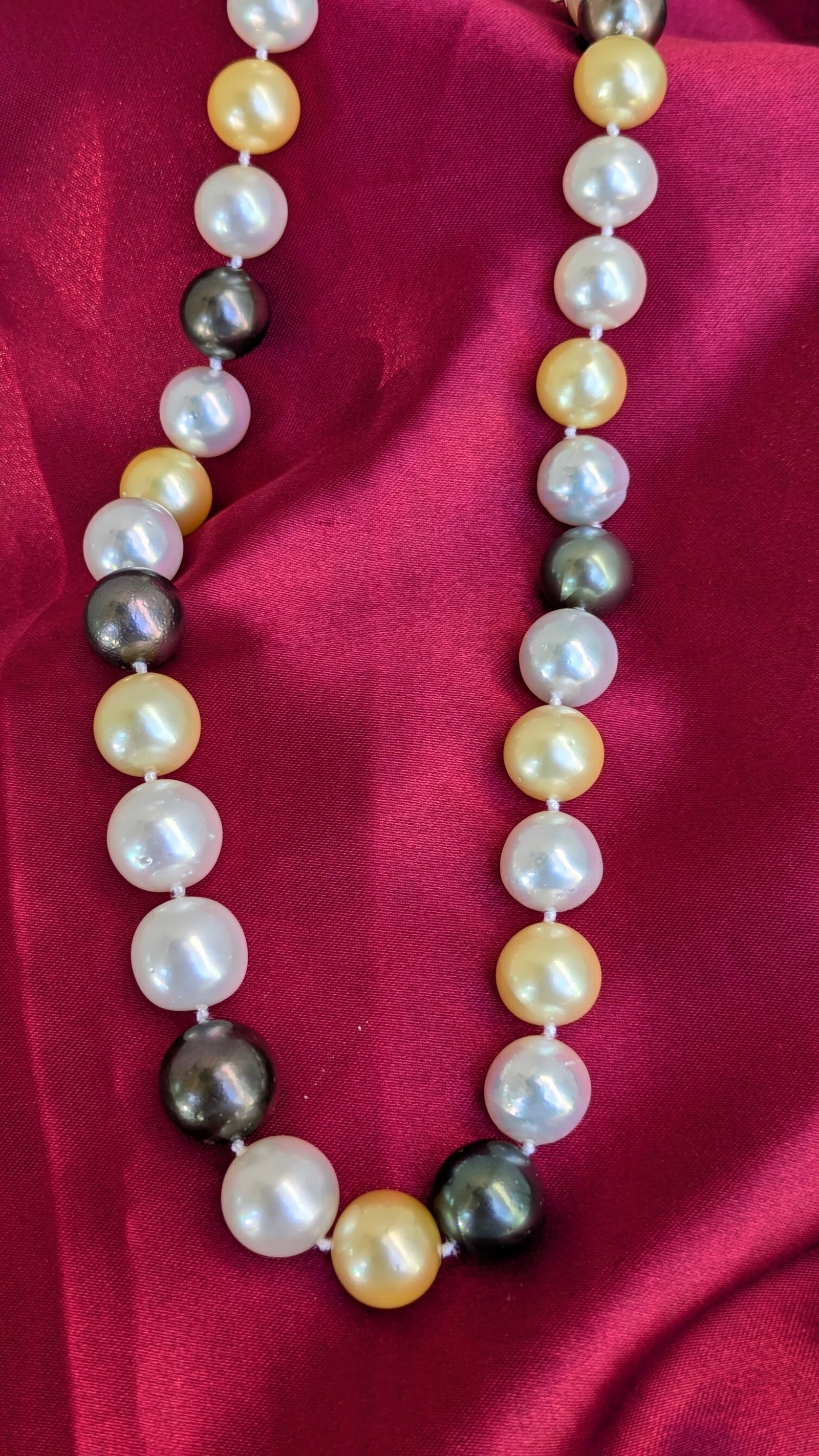 Multi Colored Pearl Necklace: The clasp is crafted in 14k white gold featuring white, grey and cream colored pearls. The pearls measure 12.4mm and the necklace is 18in in length.