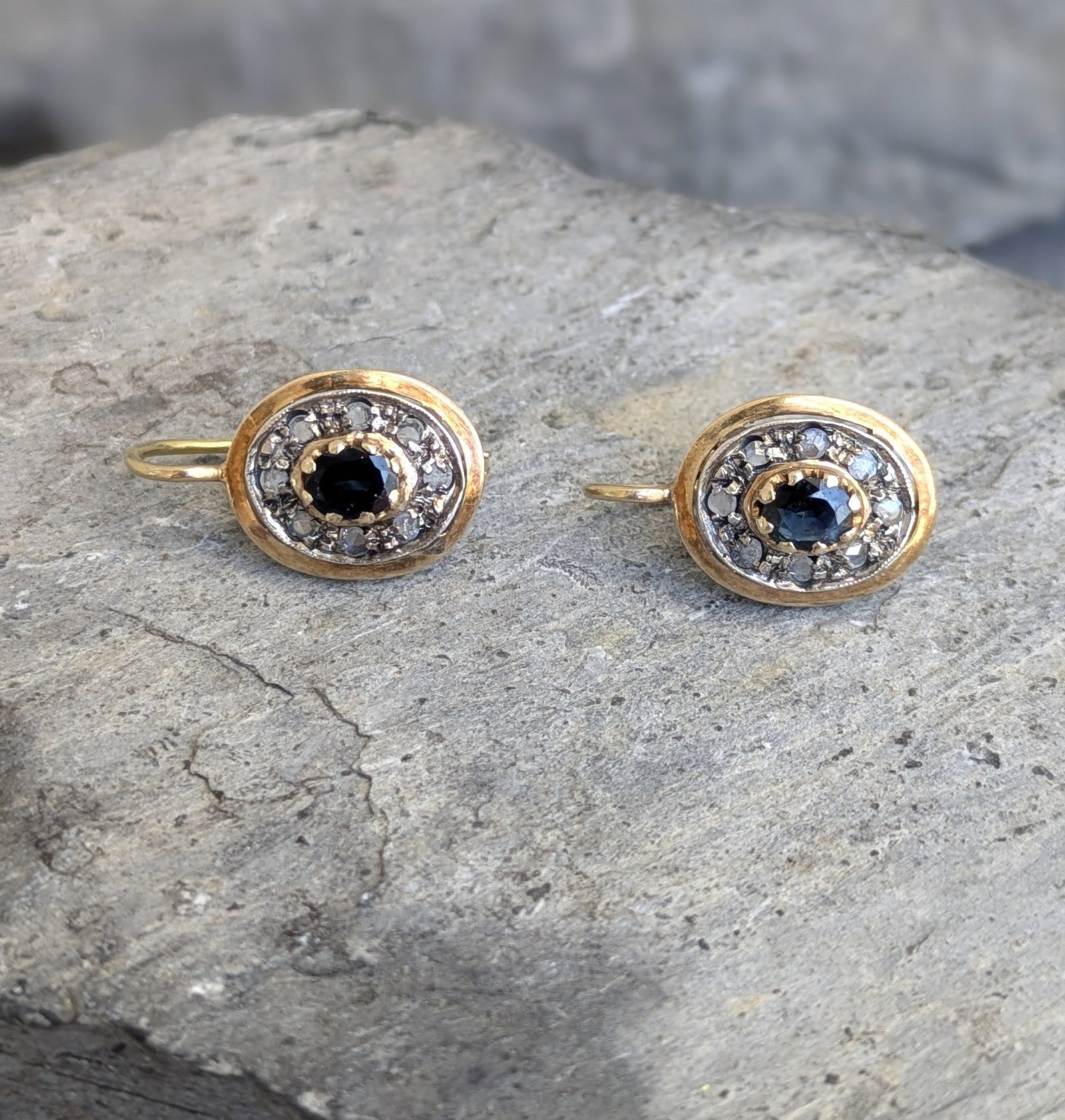 Vintage Italian Sapphire and Diamond Earrings: Crafted in 18k yellow gold and sterling silver featuring (2) oval sapphires and (16) rose cut diamonds. The earrings measure 1in x 1/2in and weigh 3.2dwt