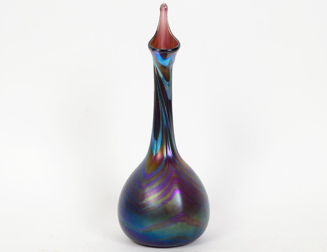 CHARLES LOTTON ART GLASS VASE: Contemporary. Etched signature Lotton. Dated 1973. The iridescent blue swirled spherical vase with long neck with an upward-pulled rim. Height 12 ¼”. (Cond: good) (150/200)