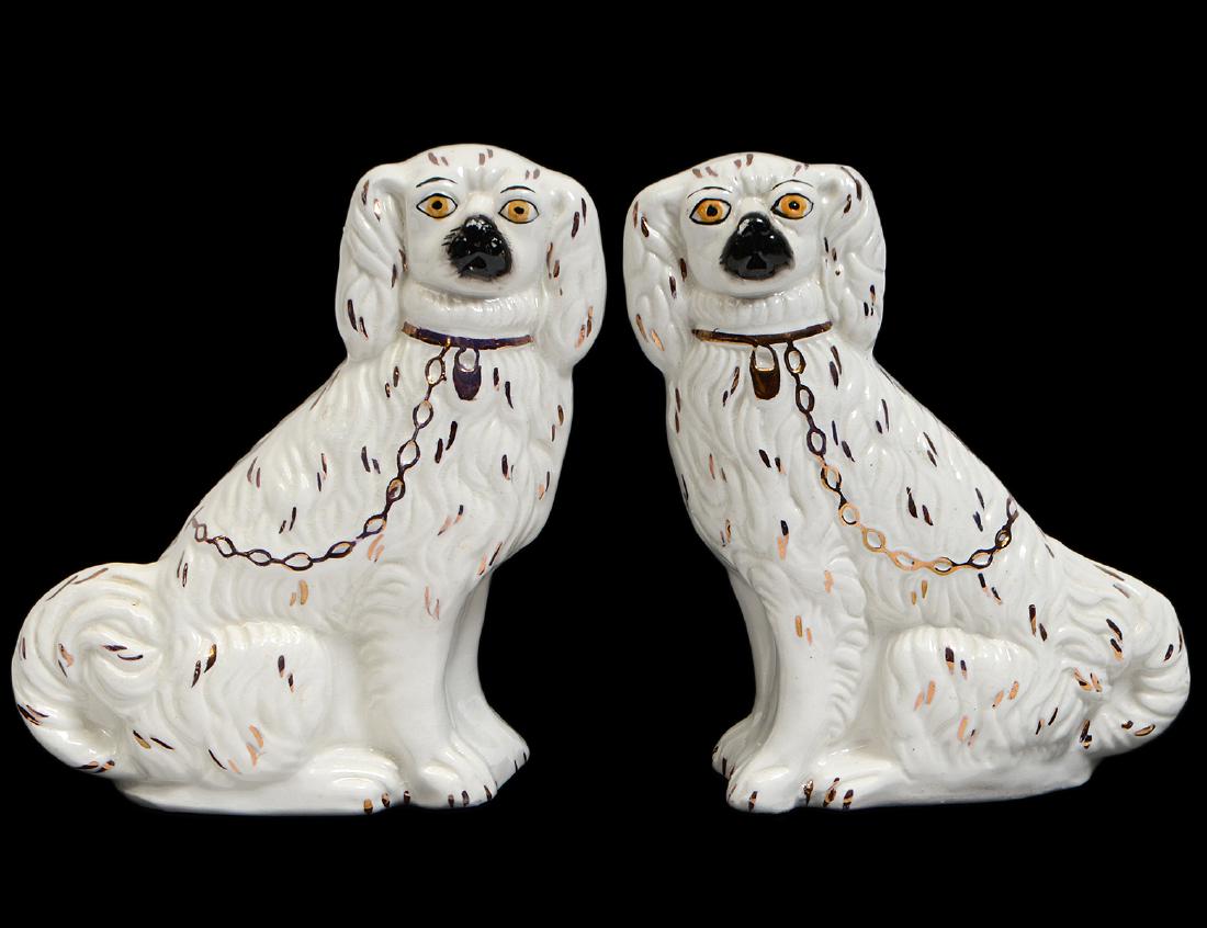 PAIR OF STAFFORDSHIRE PARCEL GILT CREAMWARE SPANIELS: Late 19th Century. Marked Staffordshire England. Height 7”. Width 5”. (Cond: good overall, areas of color slightly worn) (100/150)