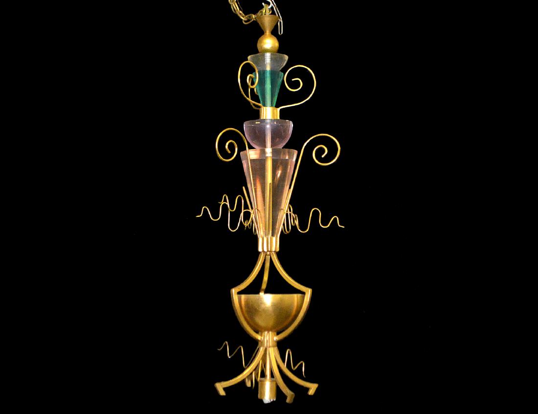 MEMPHIS STYLE BRASS & LUCITE PENDANT CEILING LIGHT: Circa 1980. Van Teal. Composed of various colored Lucite elements affixed to a brass-stylized standard, lacking lower shade, electrified. Height 44” (approx.) (Cond: lacks lowest Lucite element) (15