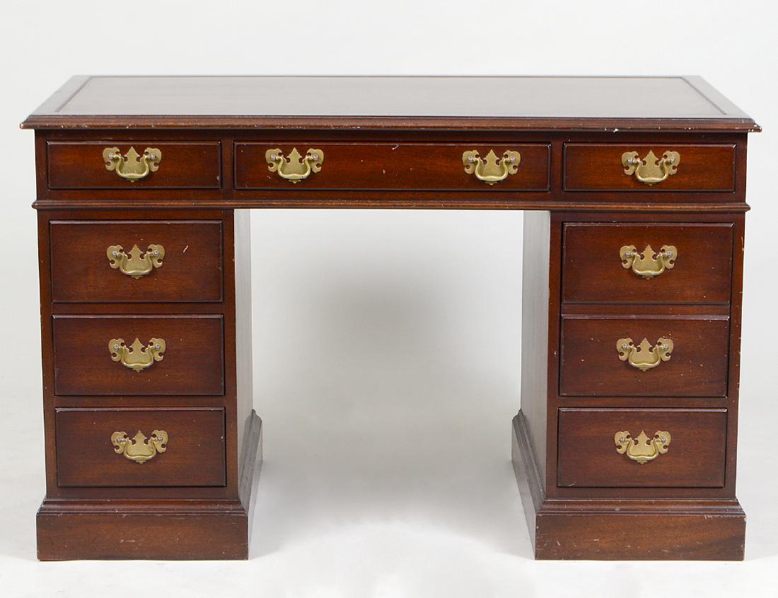 KITTINGER GEORGIAN STYLE MAHOGANY PEDESTAL DESK: Modern. Labeled. The single unit desk with three frieze drawers above two banks of three short drawers, on a shaped plinth. Height 30”. Width 48”. Depth 28 ½”. (Cond: good) (300/400)