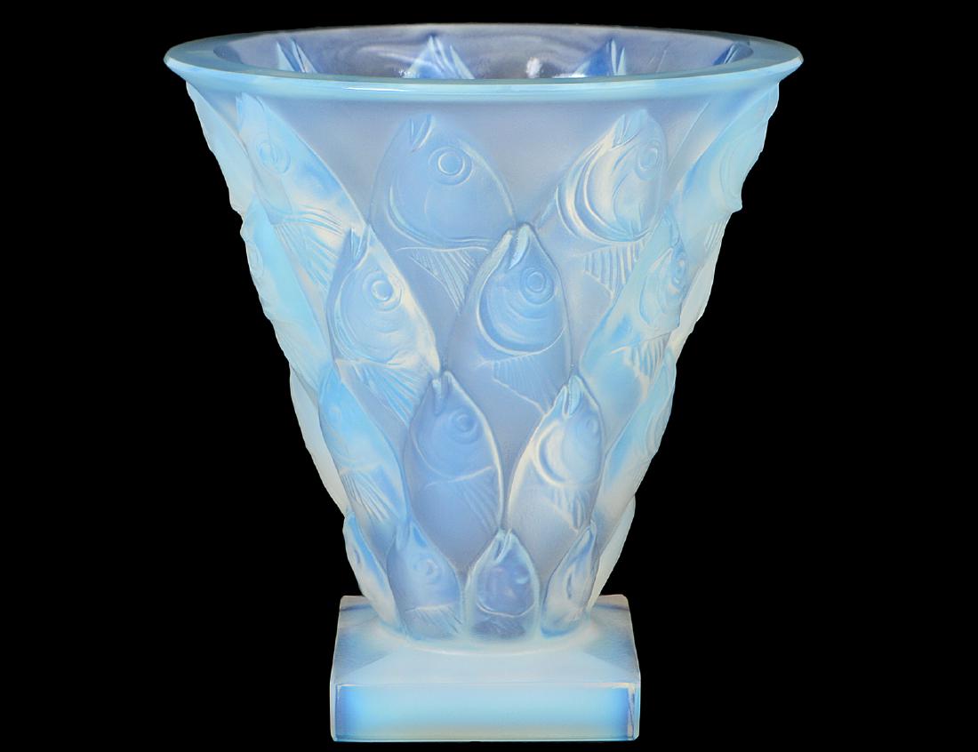 SABINO ART DECO OPALESCENT GLASS PISCES VASE: French. Circa 1935. Signed Sabino Paris, and with a paper label. The conical blue hued colorless vessel with rows of molded layered fish, on a square base. Height 5 ½”. Diameter 5”. (Cond: good) 