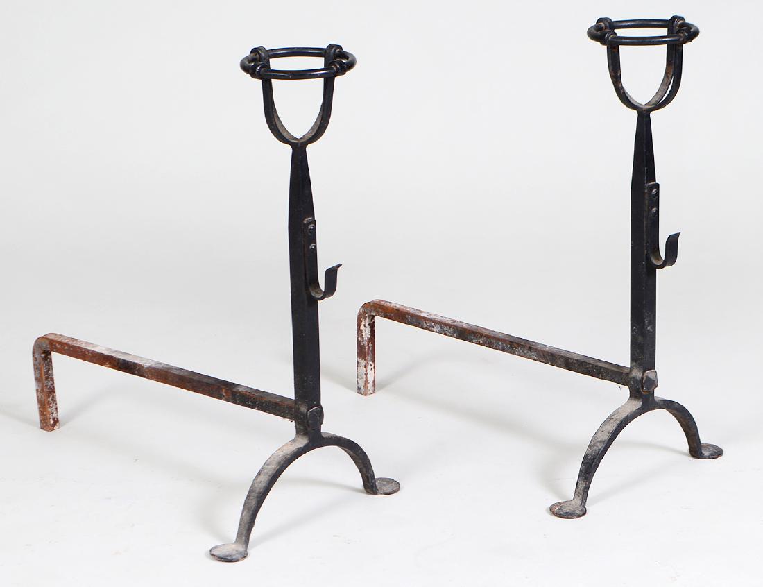 PAIR OF CONTINENTAL IRON ANDIRONS: 18th/19th Century. Probably French. Each standard surmounted by open cups, and with hooks. Height 25”. Depth 21”. (Cond: good) (100/150)