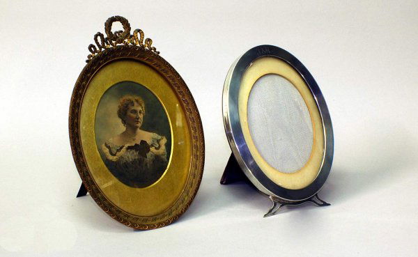 2 Picture Frames Including Sterling: Two Picture Frames Including Sterling Standing Oval Center Monogrammed Frame Measuring 8 1/2 inches by 6 inches. Stamped sterling. The second is an ornate pierced brass B. Altman picture frame measuri