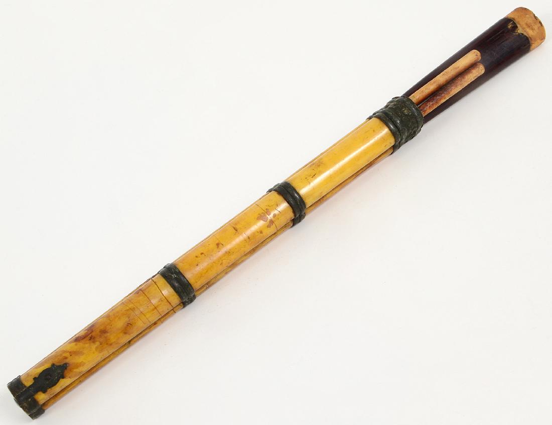 SINO-TIBETAN KNIFE/CHOPSTICK TRAVEL EATING SET: 19th Century. The metal mounted bone case, with a wood and bone knife handle, the bone chopsticks undecorated. Length 12 ¼”. (Cond: minor losses, repairs to case and knife handle) (150/200)