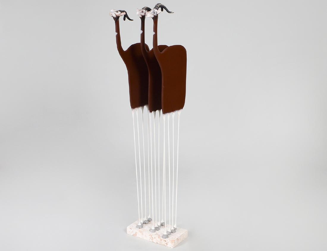 TODD WARNER MIXED MEDIA ANTELOPE GROUP: (American. Born 1845) Signed and dated on each of the three antelope, Todd J. Warner, 89. Depicting three spiral horned white-faced reddish brown bovine, each with a differing expression, on a coral b