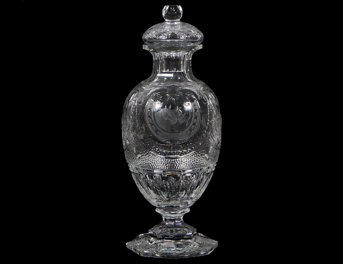 FINE THOMAS WEBB GLASS EQUESTRIAN DECANTER: Circa 1955. Marked beneath the foot with acid-etched Webb monogram. The Colorless glass body intaglio and wheel cut with two horse heads within a horseshoe, the whole engraved with festoons above scal