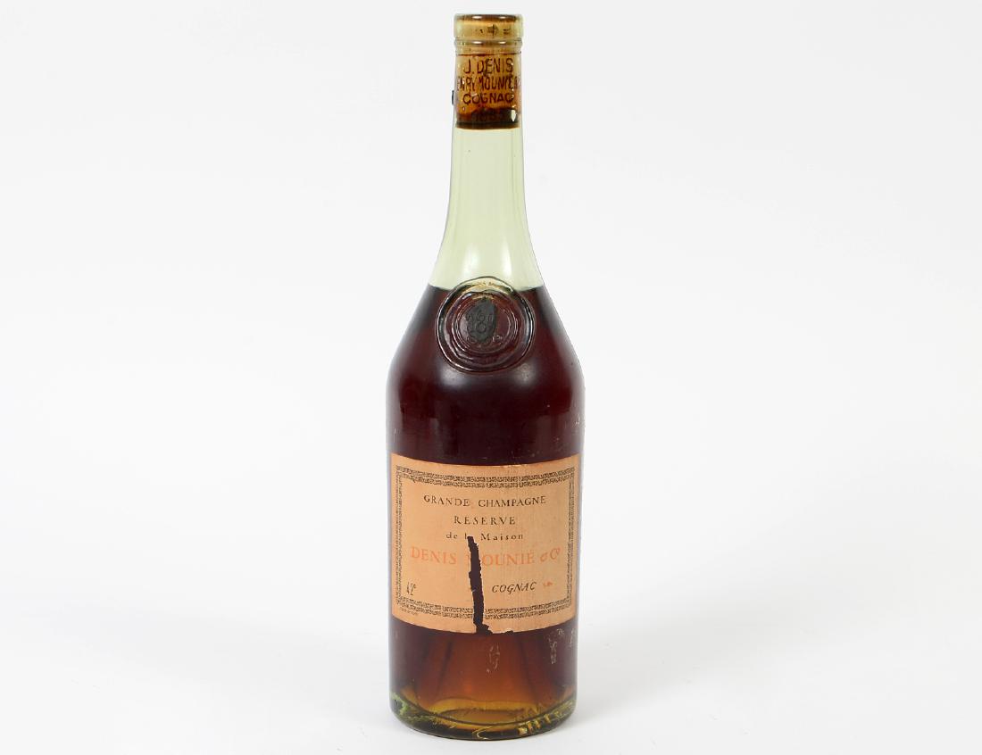 J. DENIS & HENRY MOUNIÉ & CO., GRANDE CHAMPAGNE: Printed cork, original paper label (vertical tear) impressed circular seal, remnants of black wax, impressed 189?. [Color transparent reddish brown. Purchased from a wine merchant in Paris, circa 1956