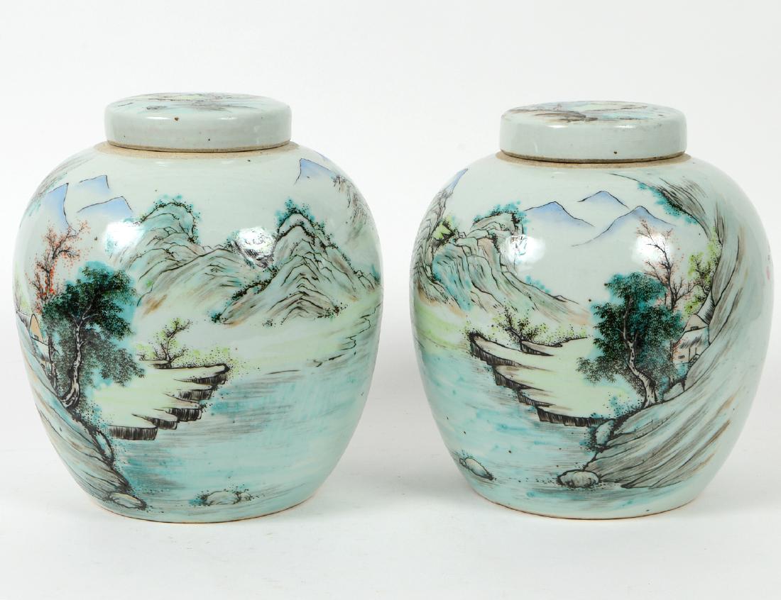 PAIR OF CHINESE FAMILLE VERTE PORCELAIN COVERED GINGER: JARS Circa 1900. Of spherical form, with flat top lids, decorated allover with landscapes, dotted with figures. Height 10". Diameter 9". (1000/1500)