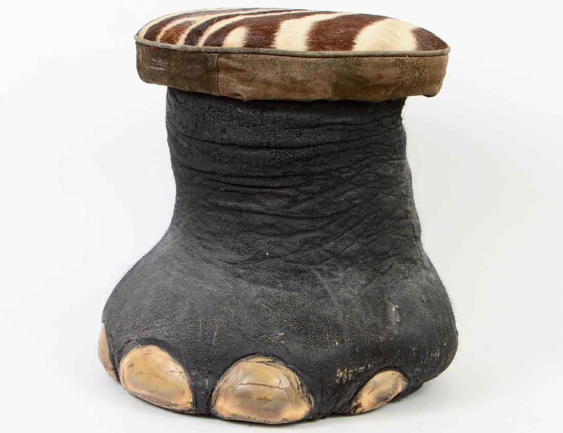 ELEPHANT FOOT STOOL: With a zebra skin seat. Height 17 1/2". Width 19" (approx.) (Cond: wear, some surface losses)