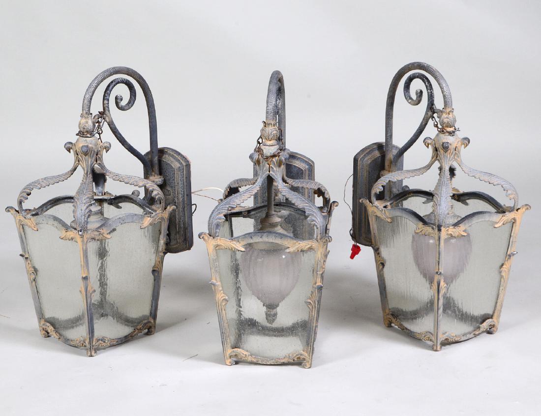 SET OF THREE PATINATED METAL & GLASS COACH LANTERNS: En suite with the two preceding lots. Height 21 1/2". Width 13". (Cond: good)