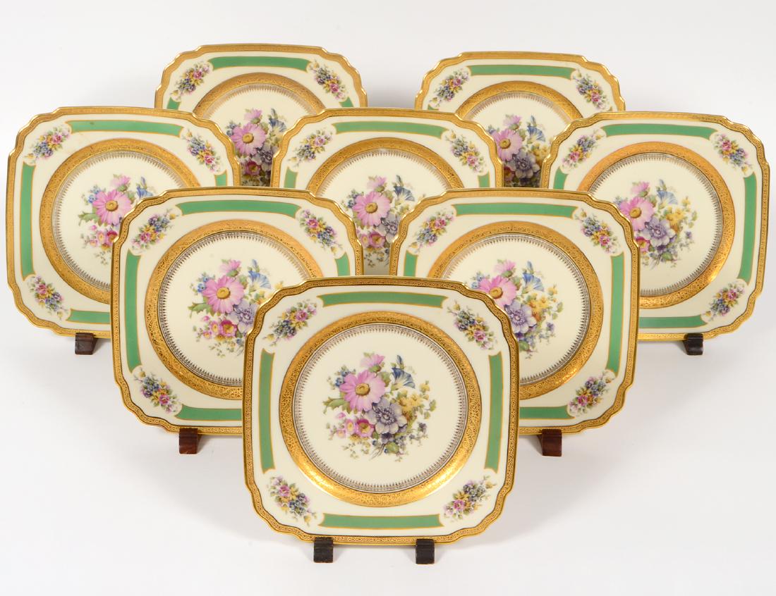 SET OF 8 BOHEMIAN PAINTED PORCELAIN DESSERT PLATES: Circa 1900. Marked on the underside, in the "Royal Ivory" pattern. Square with canted corners, the recess and corners elegantly painted with a floral spray with green and gilt borders. Width square 8"