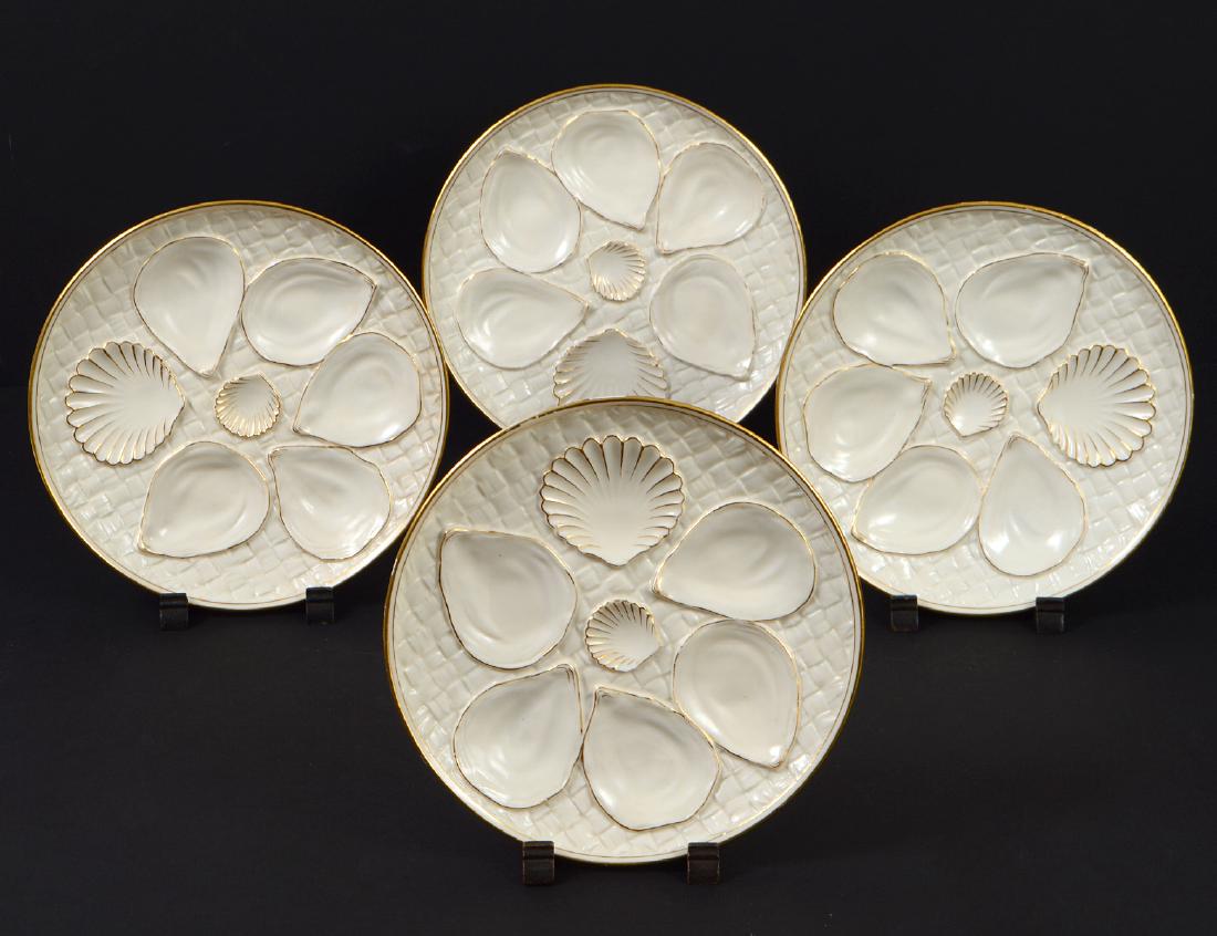 SET OF FOUR ROYAL WORCESTER PORC OYSTER PLATES: The undersides with monogram for Royal Worcester, model 1170. Each molded with oyster and clam recesses, with gilt highlights. Diameter 8 1/2".