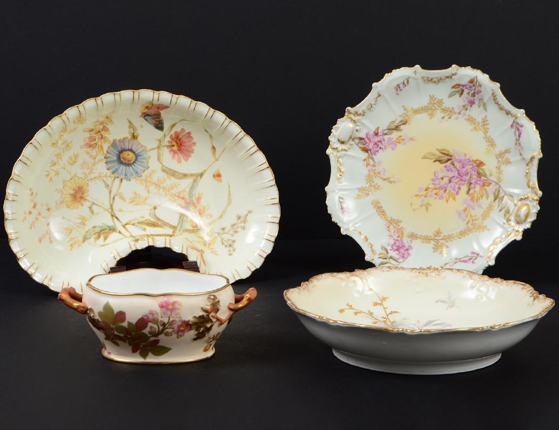 FOUR ENGLISH & FRENCH PORCELAIN TABLE ITEMS: Late 19th/Early 20th Century. Comprising: a Royal Worcester two handled sauce tureen/sugar bowl, a Limoges foliated decorated shallow bowl, a crescent shaped bowl and another plate. Width of crescent 