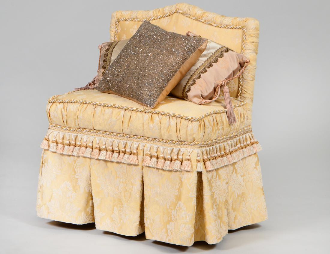 CONTEMPORARY CUSTOM UPHOLSTERED BOUDOIR SEAT: Upholstered in a yellow silk damask, with fleur d’ Lys, a ruffled skirt and a fringe border. Height back to floor 32". Height seat to floor 19". Width 32". (Cond: almost new)
