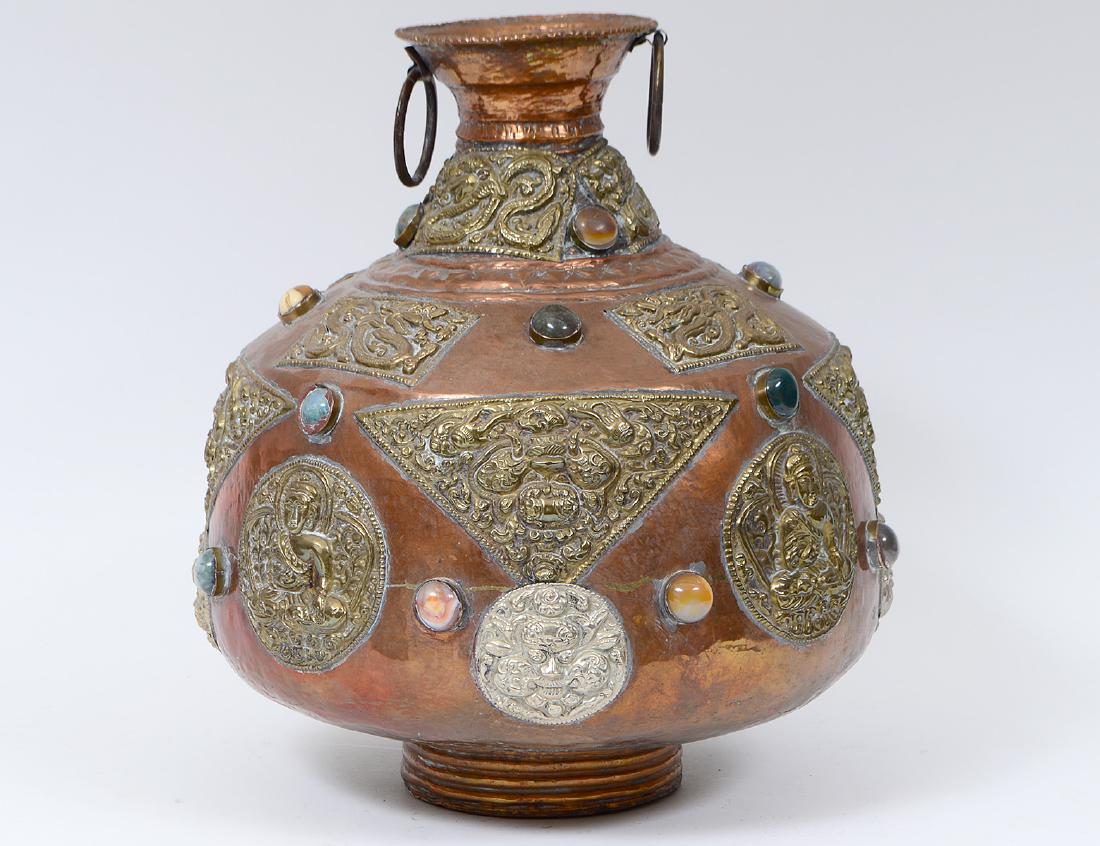 SOUTHEAST ASIAN HARDSTONE INSET BRASS VASE: Hammered with various Buddhist panels. Height 14 1/2.