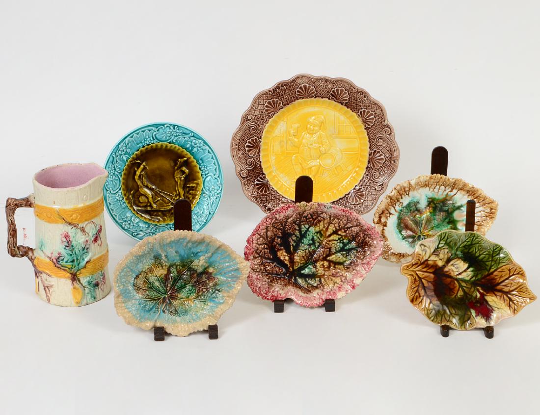 FOUR MAJOLICA LEAF DISHES, TWO FIGURAL DISHES & A: Late 19th/20th Century. The set of four English, in varying colors; the dishes, probably German, depicting two elves riding a snail or an elderly gentleman merrymaking in a tavern; the pitcher English