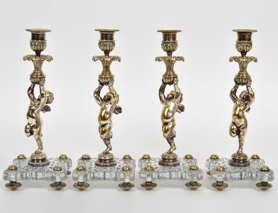 SET OF FOUR SILVERED METAL & CUT GLASS FIGURAL: Early 20th Century. Probably Italian. Each in the form of a winged putto, en suite with the next two lots. Height 11 1/4". (Cond: good) PROVENANCE: From The Collection of The Heirs of William Fox (Pro