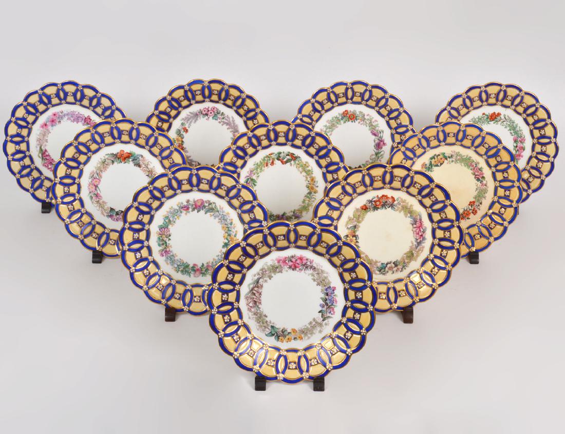 TEN ENGLISH MOLDED PAINTED PORCELAIN DESSERT PLATES: Mid to late 19th Century. Spode, marked on the underside. Each shaped circular plate with a stylized basket molded rim and painted foliate garland recess. Diameter 8 1/2". (Cond: good). PROVENANCE: Fr
