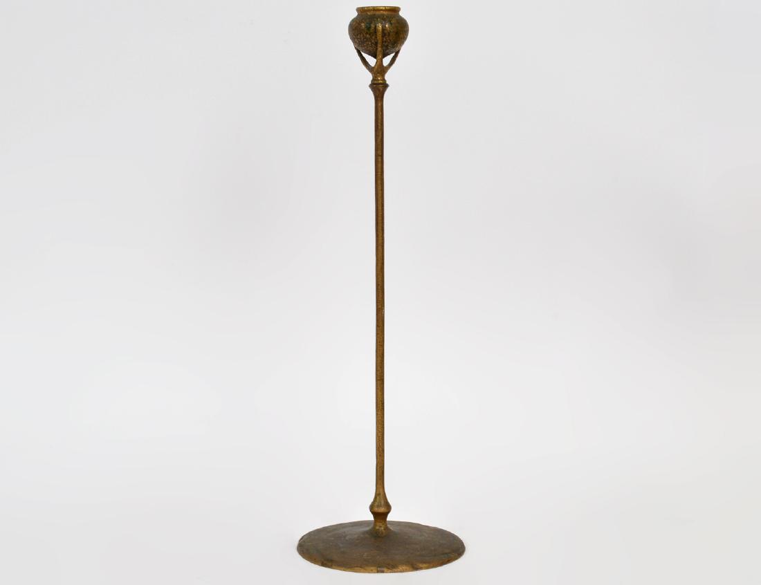 TIFFANY STUDIOS GILT BRONZE TALL CANDLESTICK: Circa 1900. Signed Tiffany Studios, New York. Numbered 1213. The bud form nozzle above a slender stem, on circular foot. Height 18 1/2". (Cond: finish distressed)