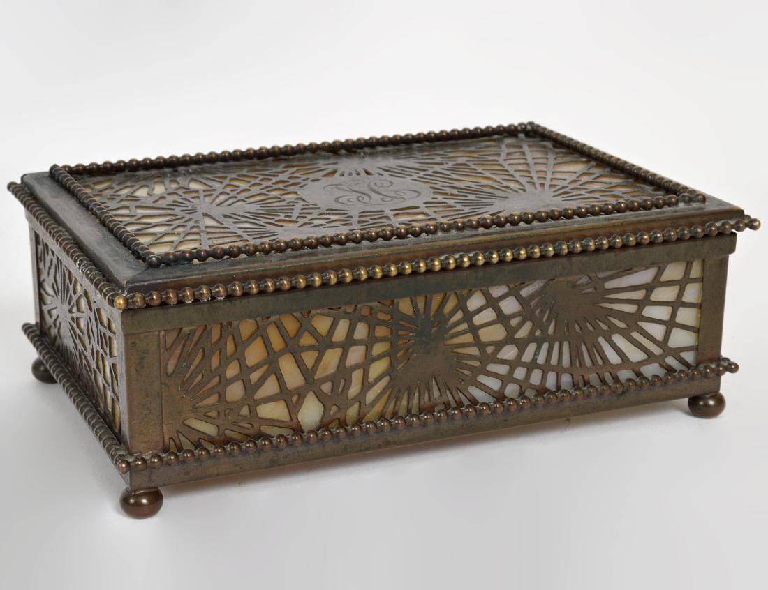 TIFFANY STUDIOS BRONZE & AMBER GLASS BOX: Circa 1900. Signed Tiffany Studios, New York. In Spider Web pattern. Rectangular, with beaded borders and ball feet. Length 6". Width 4". (Cond: good)