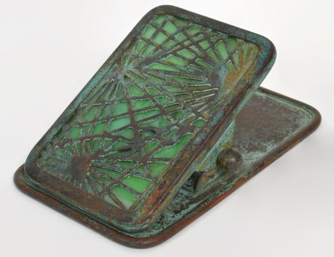 TIFFANY STUDIOS BRONZE & GREEN GLASS PAPER CLIP: Circa 1900. Signed Tiffany Studios, New York. Numbered 971. The patinated bronze cast in the spider pattern, with green slag glass. Length 3". (Cond: good)