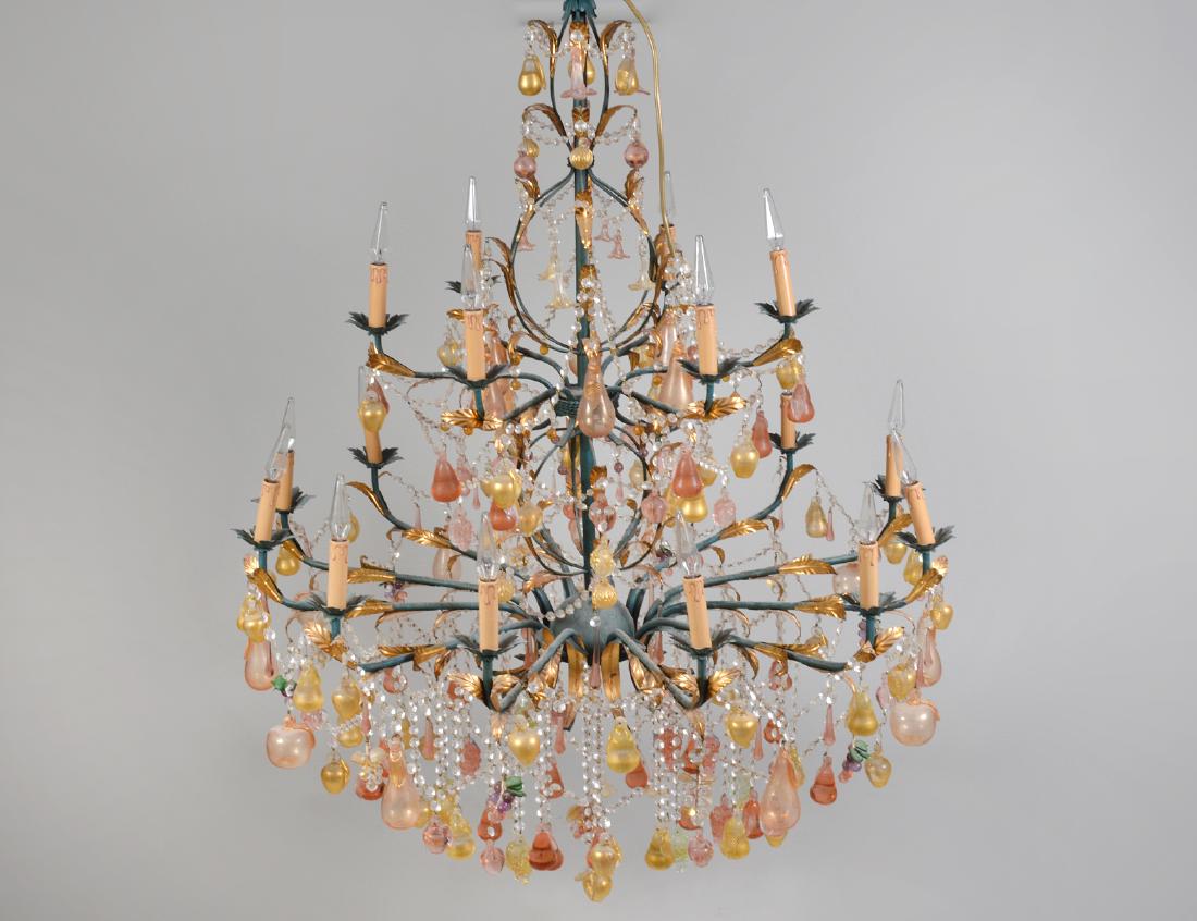 VENETIAN ROCOCO STYLE EIGHTEEN-LIGHT GLASS & METAL: Murano. Circa 1970. The center shaft supporting two-tiers of gilt-leaf fitted scrolled arms, hung allover with gilt infused pink and colorless glass fruits, and hung with faceted glass beaded chains. 