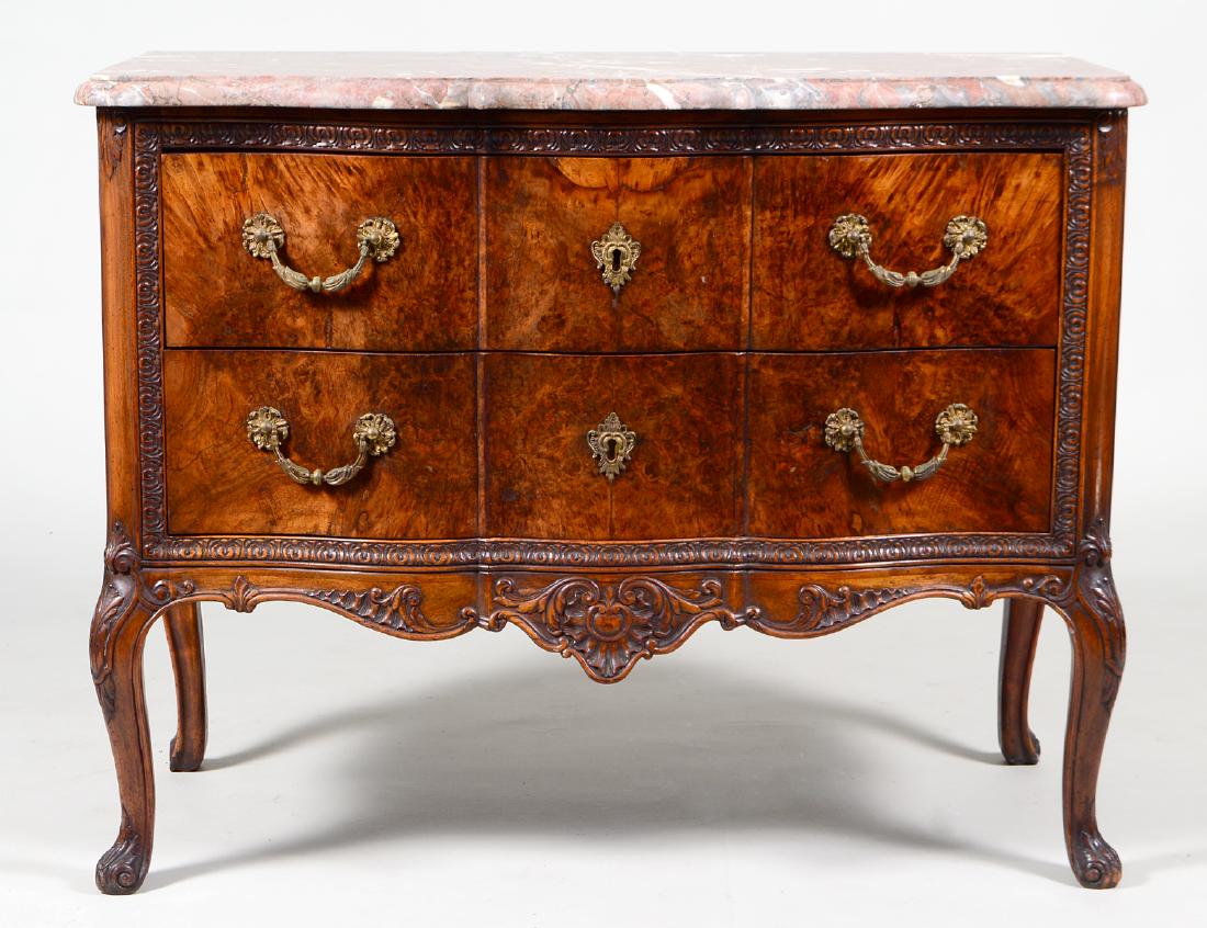 GEORGE II STYLE MARBLE TOP MAHOGANY COMMODE: Circa 1900. The serpentine gray and white veined claret marble top above a case inspired by a Chippendale design, with two deep serpentine shaped drawers, within a border of leaf tips, the drawer fron