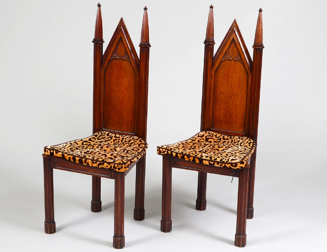 PAIR REGENY 'GOTHICK' PLANK SEAT MAHOGANY HALL CHAIRS: Circa 1820. Each with a pointed tracery carved solid back, flanked by ringed cluster columns headed by spires, the plank seats with faux tiger upholstered seat covers, on cluster column legs. (Cond: g