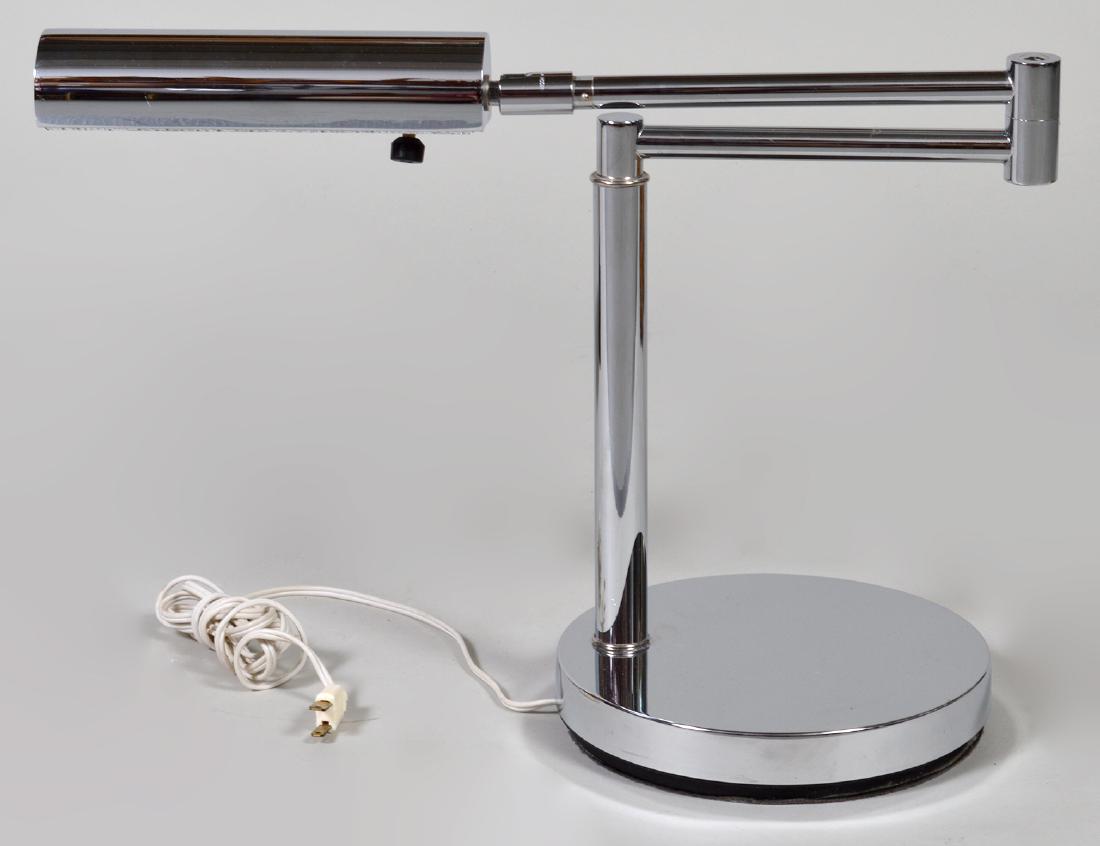 KOCH AND LOWY CHROME DESK LAMP: Circa 1970. Marked on the arm. With a swivel arm, adjustable light and circular base. Height 13 ¼”. Width 18”. (Cond: good)