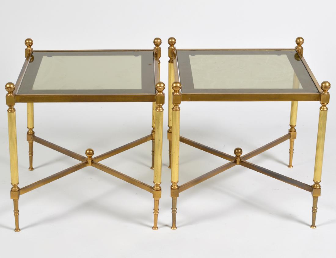 PAIR OF BRASS AND GLASS SIDE TABLES: Square, with reeded supports and a brass X-form stretcher. Height 16 ½”. Width sq. 15 ½”. (Cond: good)