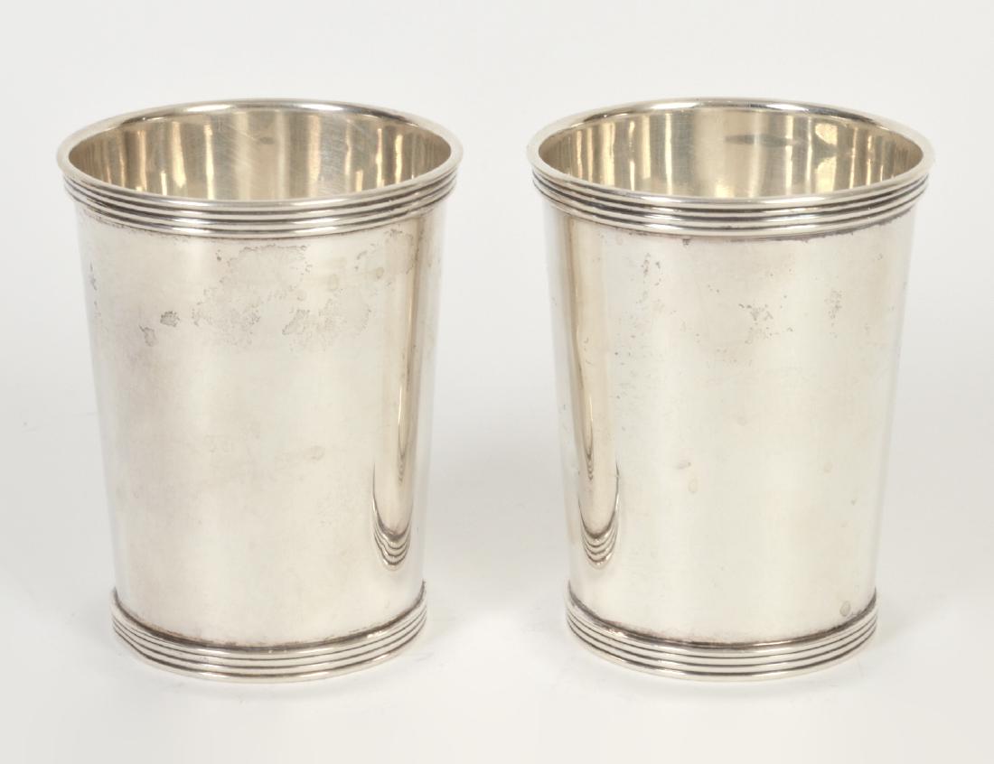 TWO AMERICAN STERLING SILVER BEAKERS: 20th Century. Marked Sterling International Silver, P 699. Troy oz 8.7. Height 3 7/8”. Diameter 3”. (Cond: good)