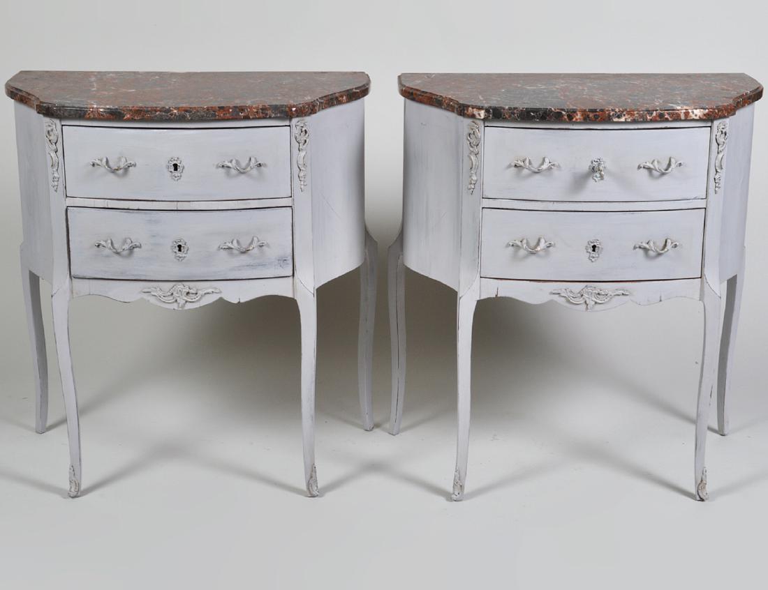 PAIR OF LOUIS XV STYLE PAINTED PETITE COMMODES: Modern. Of serpentine outline, with marble tops, painted bronze mounts, fitted with two drawers on cabriole legs, painted white. Height 28”. Width 18”. Depth 11”. (Cond: painted late