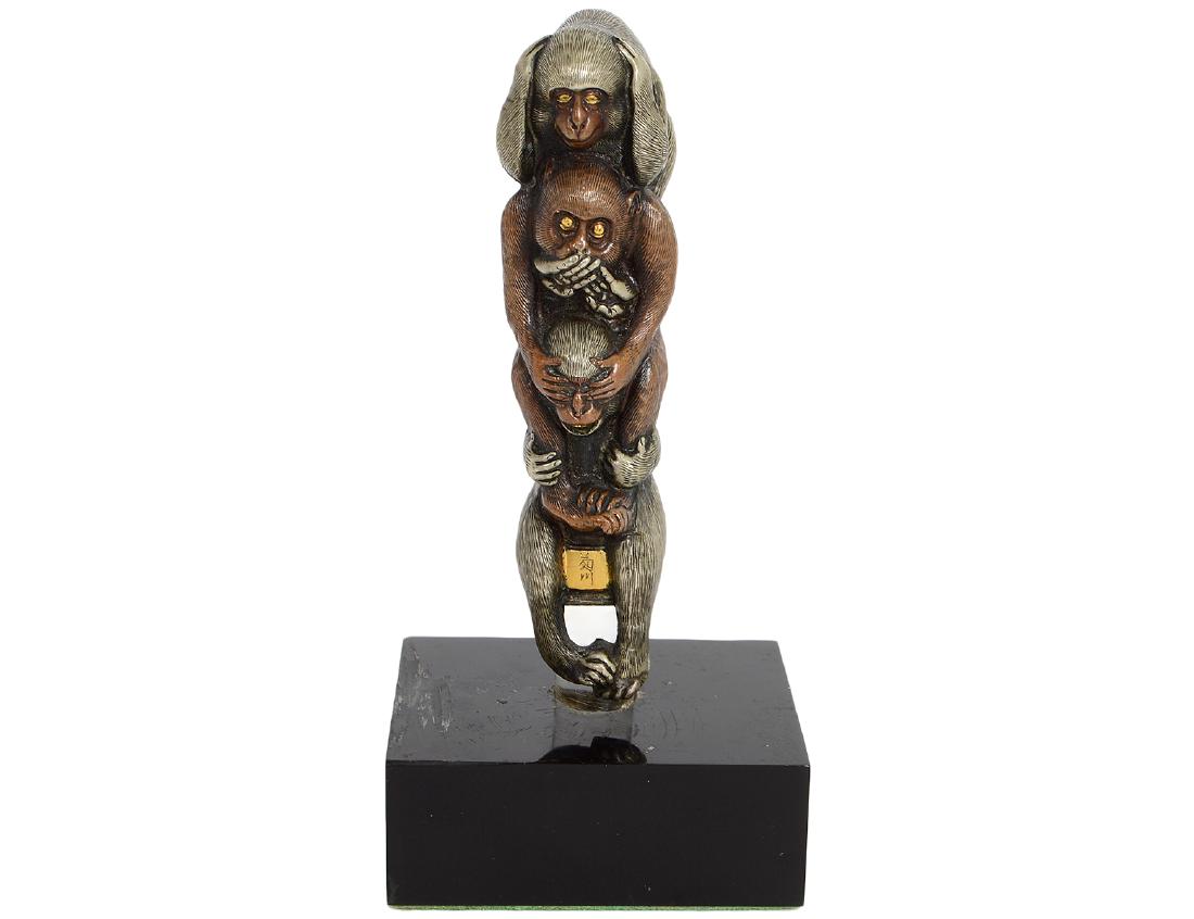 JAPANESE BRONZE, SILVER & GOLD MONKEY SCULPTURE: Meiji Period. Signed on a gold plaque. Depicting three monkeys atop one another, “see no evil, hear no evil, and speak no evil”, each with gold inset eyes, most likely a walking stick hand