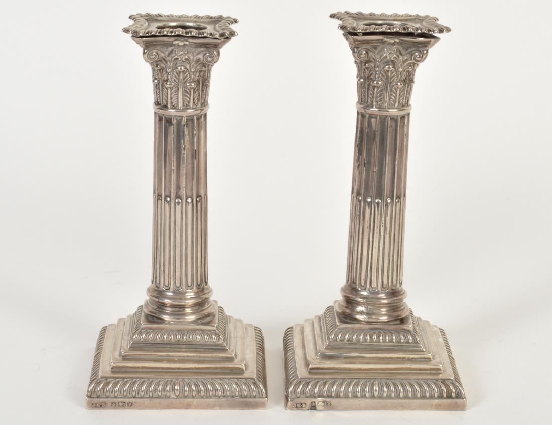 PAIR OF ENGLISH SILVER COLUMNAR FORM CANDLESTICKS: 19th Century. Hallmarked, maker’s mark. In the form of stop fluted Corinthian columns. Height 7”. (Cond: marks worn, previously weighted, now hollowed)
