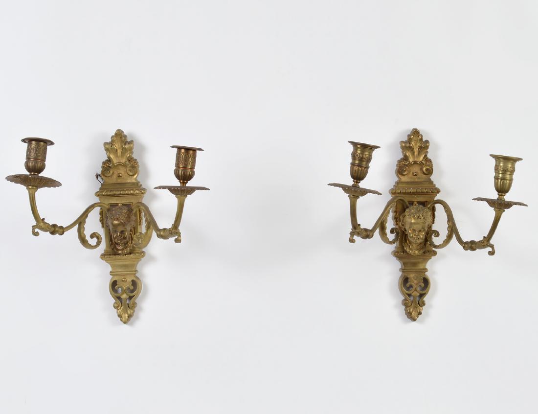 PAIR OF LOUIS XIV STYLE BRASS TWO-LIGHT SCONCES: Circa 1900. Each back-plate with a mask and up-scrolled arms. (Cond: good)
