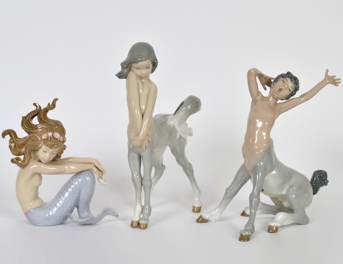 THREE LLADRO PORCELAIN MYTHOLOGICAL FIGURES: Variously marked. Comprising: two centaurs and a Mermaid, numbers 1012, 1013 and a mermaid 1413. Heights 9”, 6 ¼”, respectively. (Cond: boy with repaired tail)