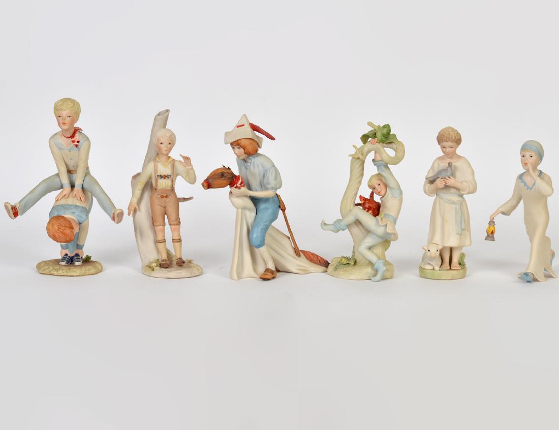 SIX CYBIS PORCELAIN FIGURES BOYS IN VARIOUS PURSUITS: Marked. Including: a boy riding a broom horse, ‘Jack and the Beanstalk’, and two boys engaged in leapfrog, each with a matte finish. Height of largest 9”. (Cond: good)