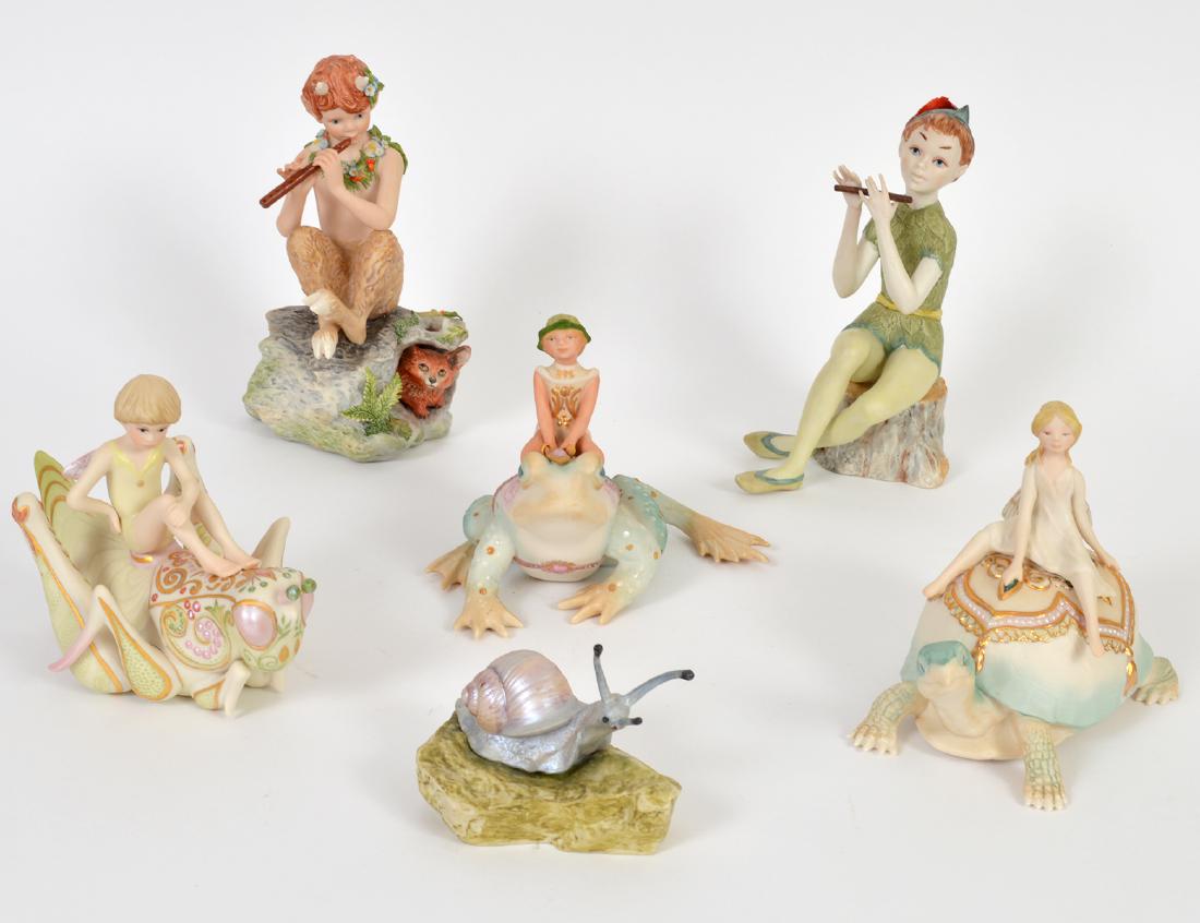 FIVE CYBIS PORCELAIN FANTASY FIGURES AND A SNAIL: Each marked. Including: a figure of Pan and Peter Pan, a boy on a frog, a fairy upon a turtle, and another atop a grasshopper, all with matte finish. Height largest 8 ¼”, smallest 3 ¼&