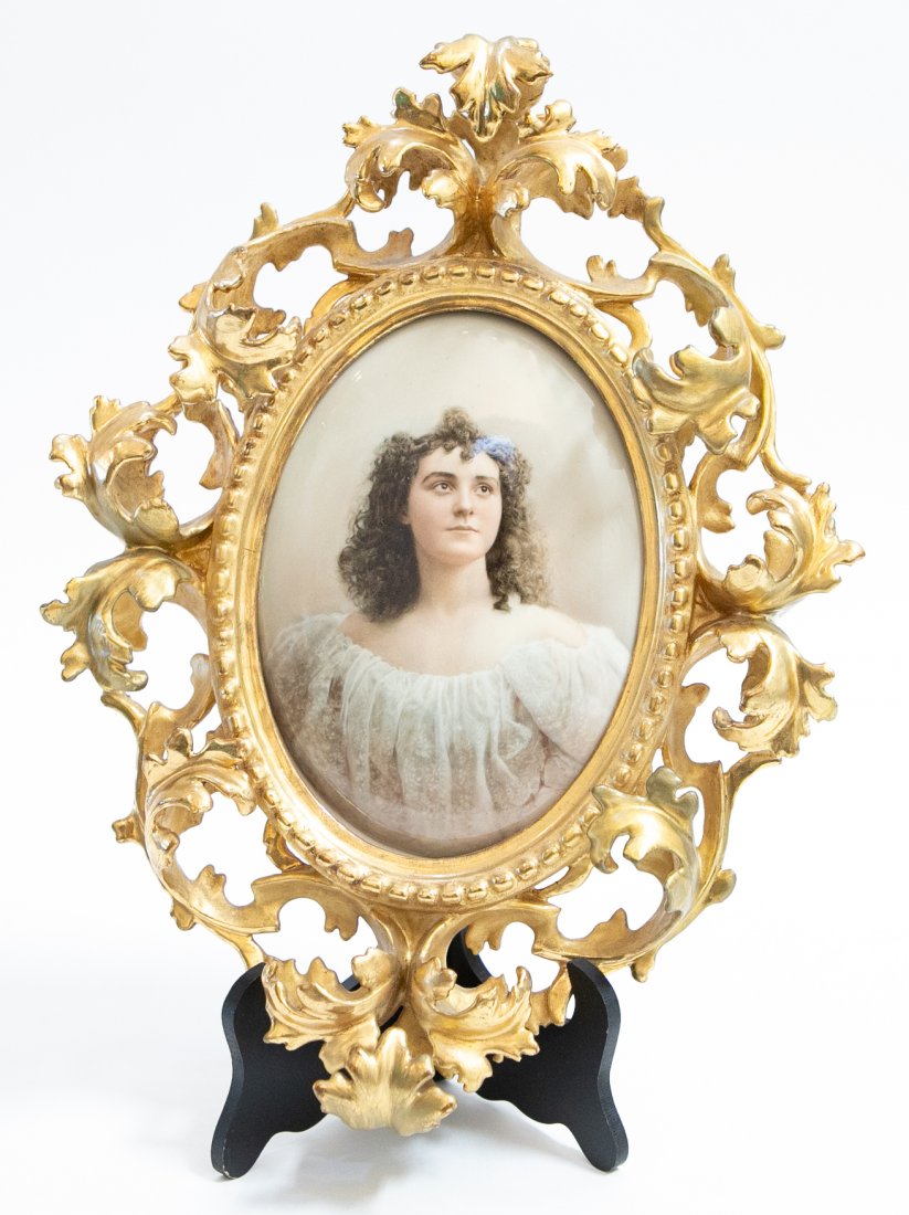 KPM PAINTED PORCELAIN OVAL PLAQUE: Early 20th Century. The reverse impressed KPM with scepter, titled Anne. In a scroll-carved gilt wood rococo style frame. Plaque 6.75 in. by 4.75 in. Overall 13 in. by 9.5 in. (Cond: both frame and pl