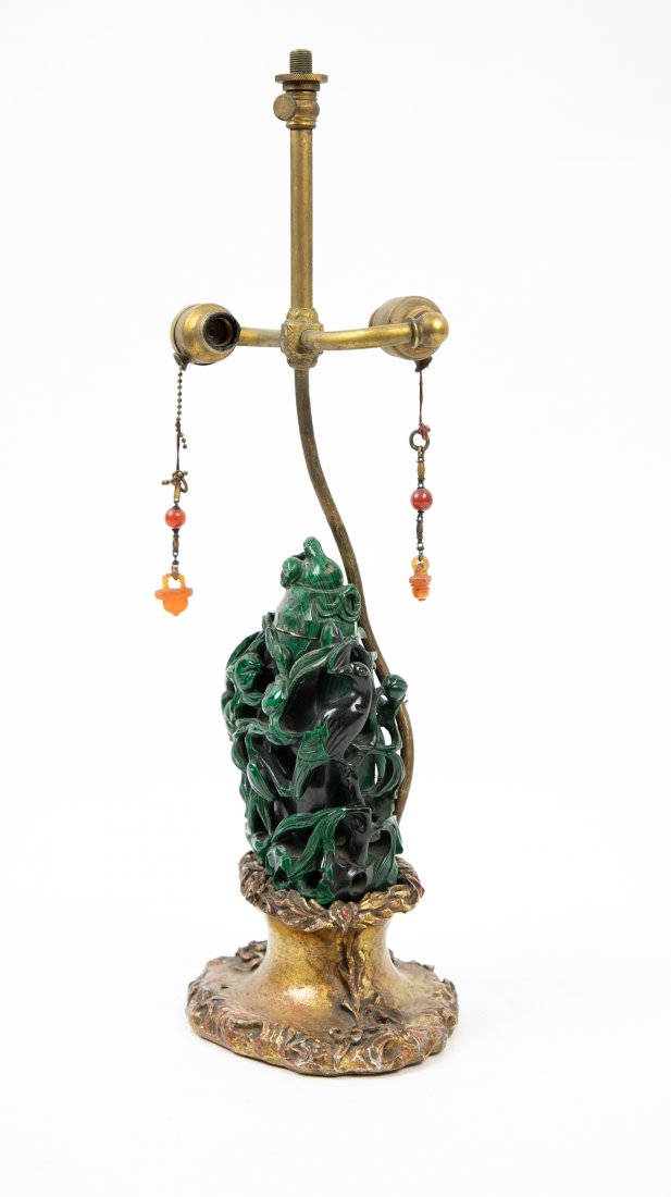 CHINESE MALACHITE LIDDED VASE, MOUNTED AS A LAMP: Early 20th Century. Of vase form, the exterior with two birds perched within a profusion of openwork foliage, on a foliate carved gilt wood base. Height of vessel 6 in. Height of vessel and base 9 in.