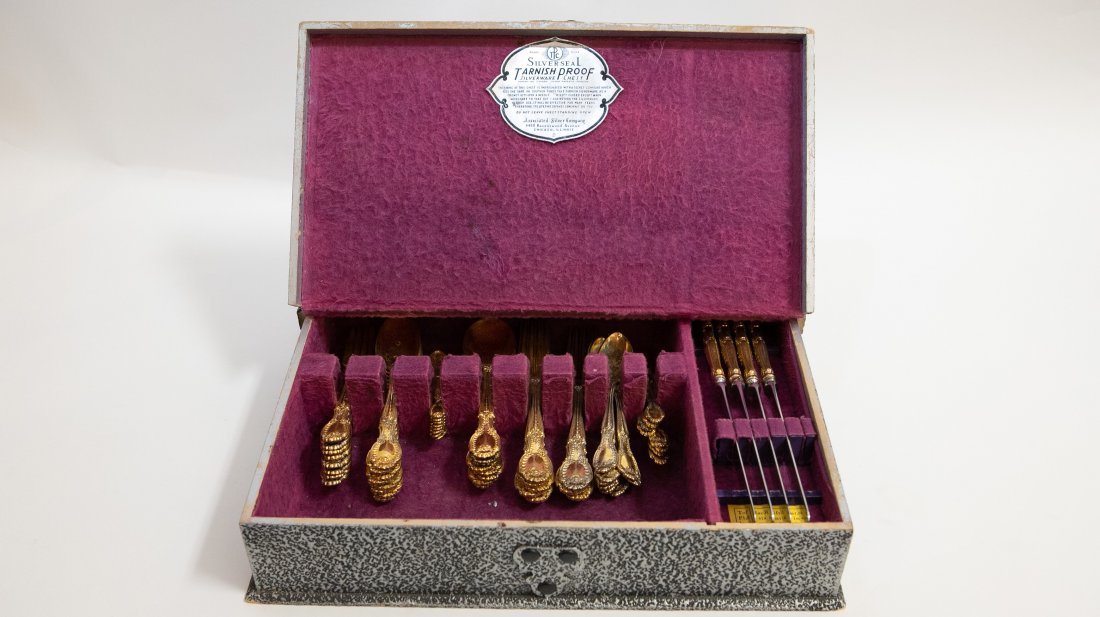 TIFFANY & CO. 64 PIECE GILT STERLING FLATWARE SERVICE: 1892. Marked Tiffany & Co., Pat, 1892. Comprising: 8 diner forks, 8 fish forks, 8 table spoons, 8 soup spoons, 8 tea spoons, 8 demitasse spoons, 8 knives and 8 butter spreads. (Cond; some wear to gilt