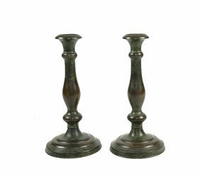 PAIR OF TIFFANY STUDIOS PATINATED BRONZE CANDLESTICKS: Circa 1900. The underside marked Tiffany Studios New York conjoined with G & D CO monogram for Tiffany Glass and Decorating Company. Of simple baluster shape with a circular spreading foot. Height 10 