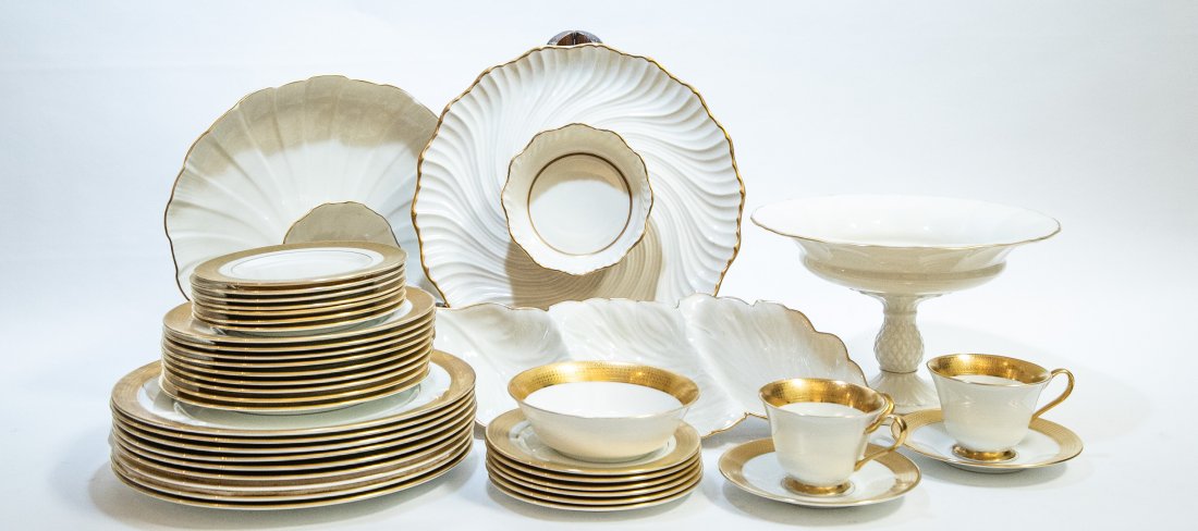 LENOX GILT DECORATED PORCELAIN PART DINNER SERVICE: Together with four associated large serving pieces. 20th Century. The undersides marked. Cream with raised gilt borders. Comprising: a tazza, a segmented serving plate, two further serving items, 16 d