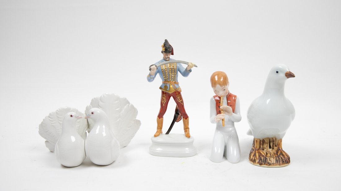 FOUR VARIED PORCELAIN CABINET/TABLE ITEMS: 20th Century. Comprising: a dove, marked with a molded Chinese character seal, a Herend group of two conjoined doves, a Herend figure of a young man with a sword and a Cybis figure of a boy. Height of