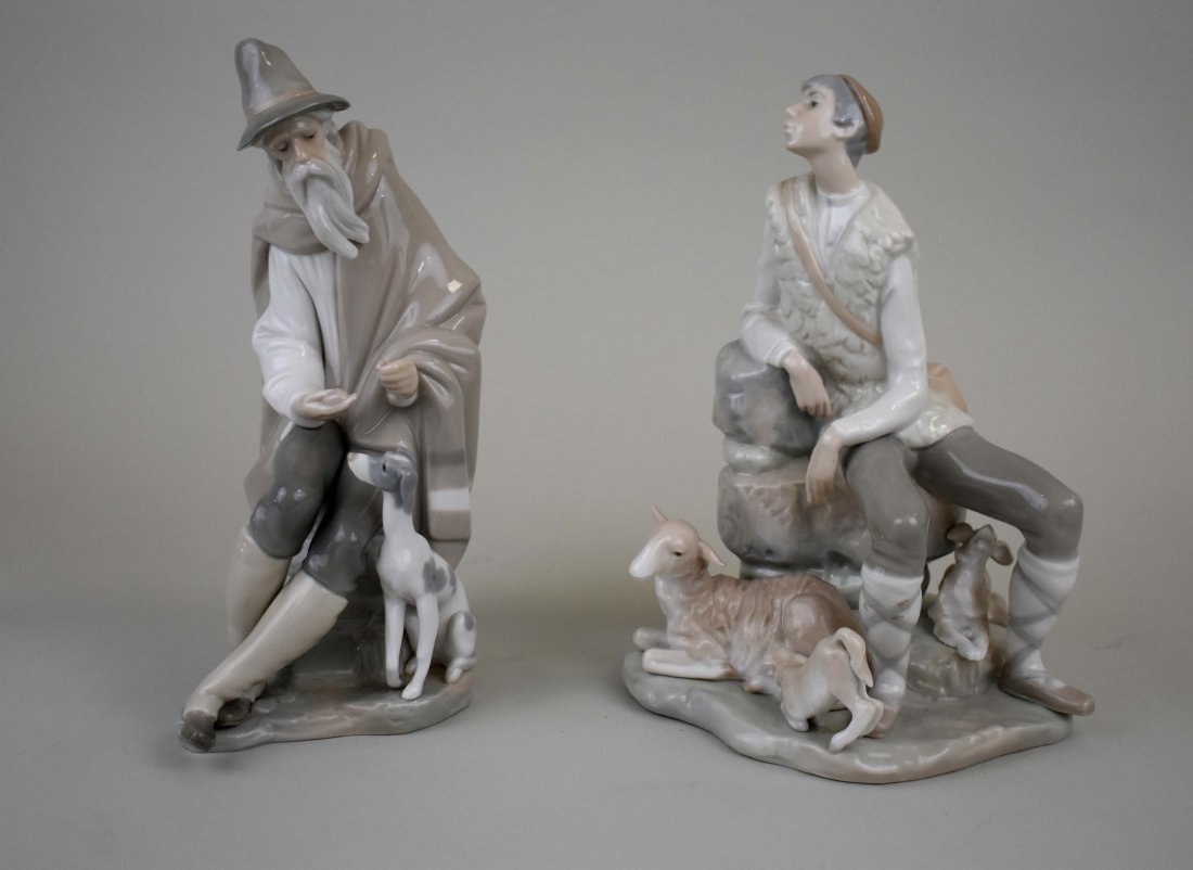 LLADRO FIGURES, A SHEPARD BOY & A BEARDED OLD MAN: Signed on the underside. The boy seated upon rocks with his dog, an ewe and lamb. The elderly man, seated upon rockwork, draped in a cloak, with his dog. Heights 10 in., 11 in., respectively. (Cond: g