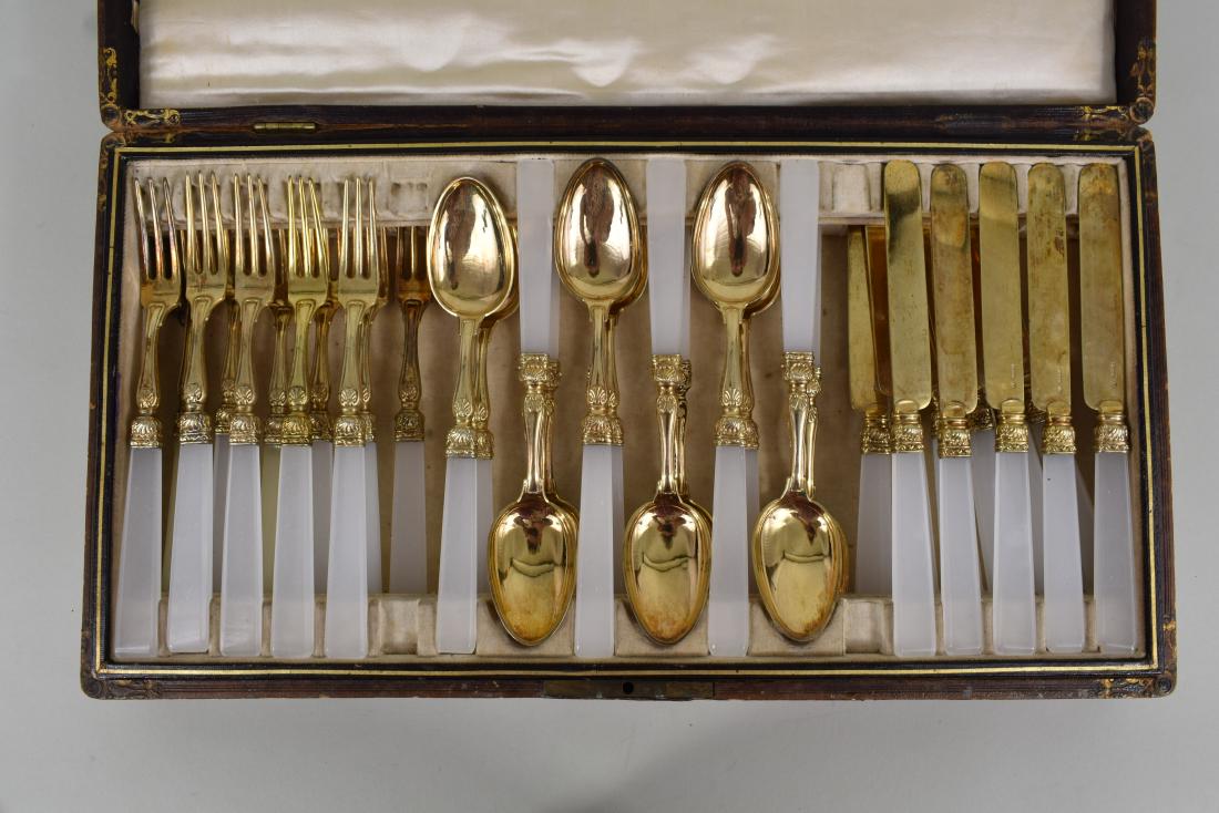 CONTINENTAL GILT SILVER & GLASS DESSERT FLATWARE SVC: Early 20th Century. The knife blades marked P. B. & Co. with the number 13 within a cartouche. The thirty-four-piece service with translucent frosted glass chamfered rectangular handles, the silver ch